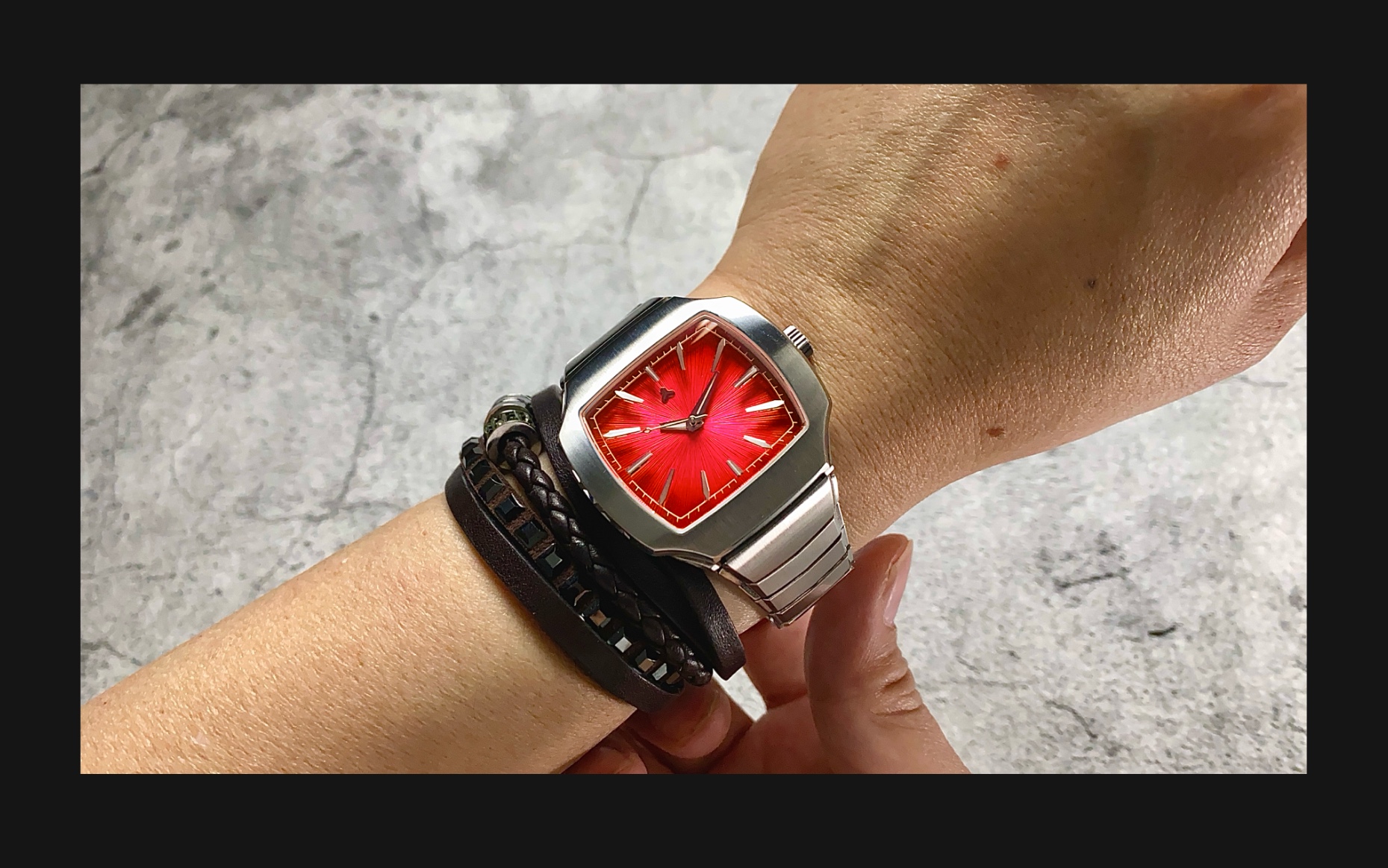 Flux Watch in Adrenaline Red on the wrist, featuring a bold red dial with silver hour markers and a stainless steel bracelet