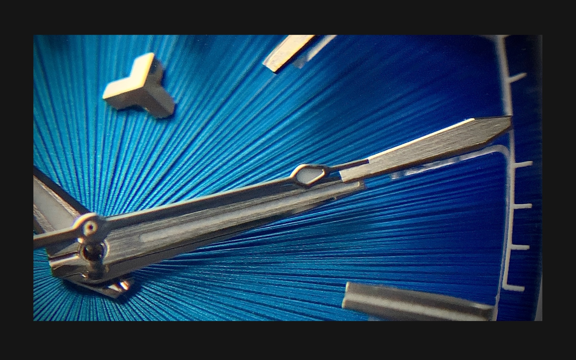 Flux Watch in Apex Blue, macro shot focusing on the Apex Blue dial and sharp silver hour markers