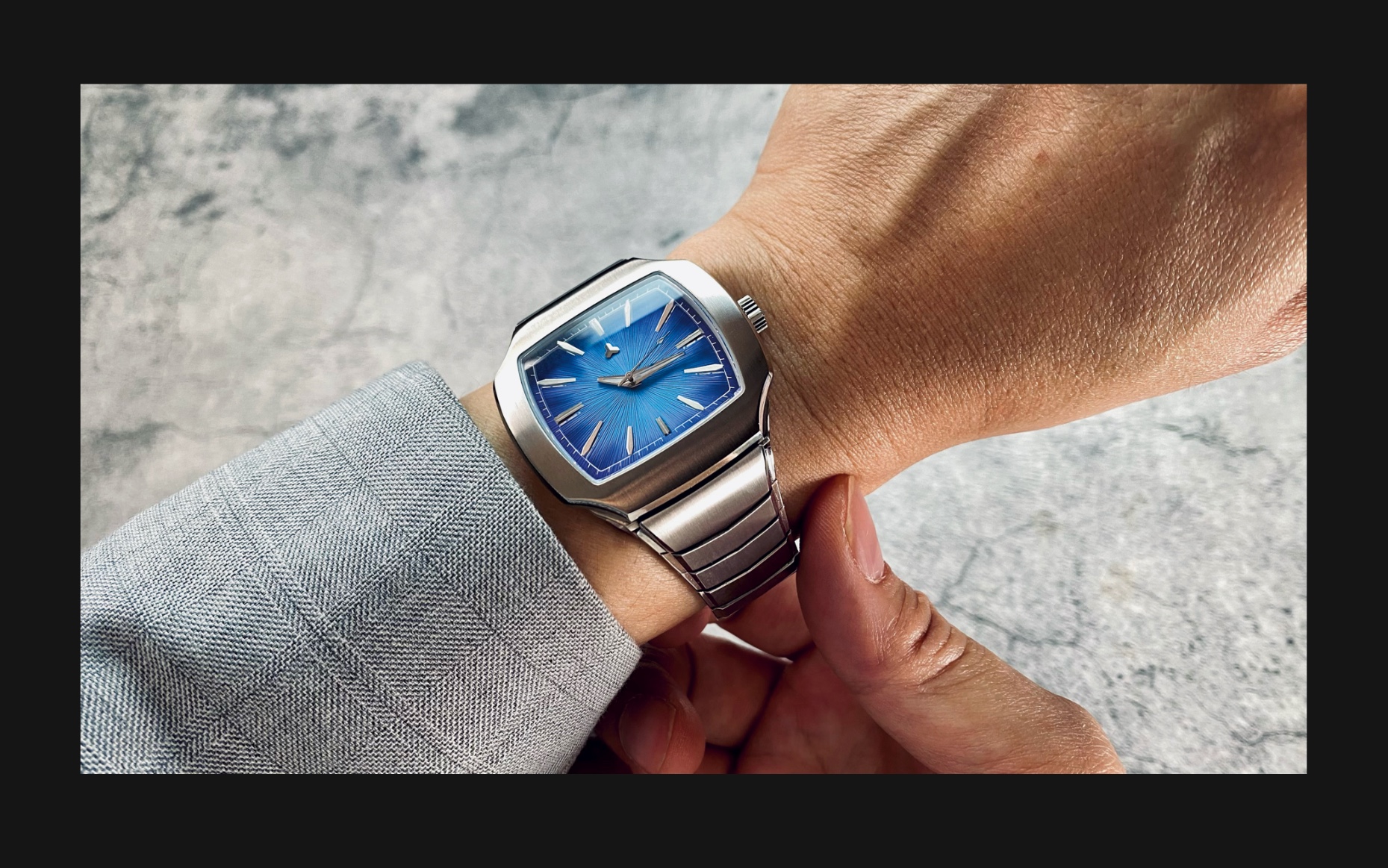 Flux Watch in Apex blue on the wrist, featuring a bold blue dial with silver hour markers and a stainless steel bracelet