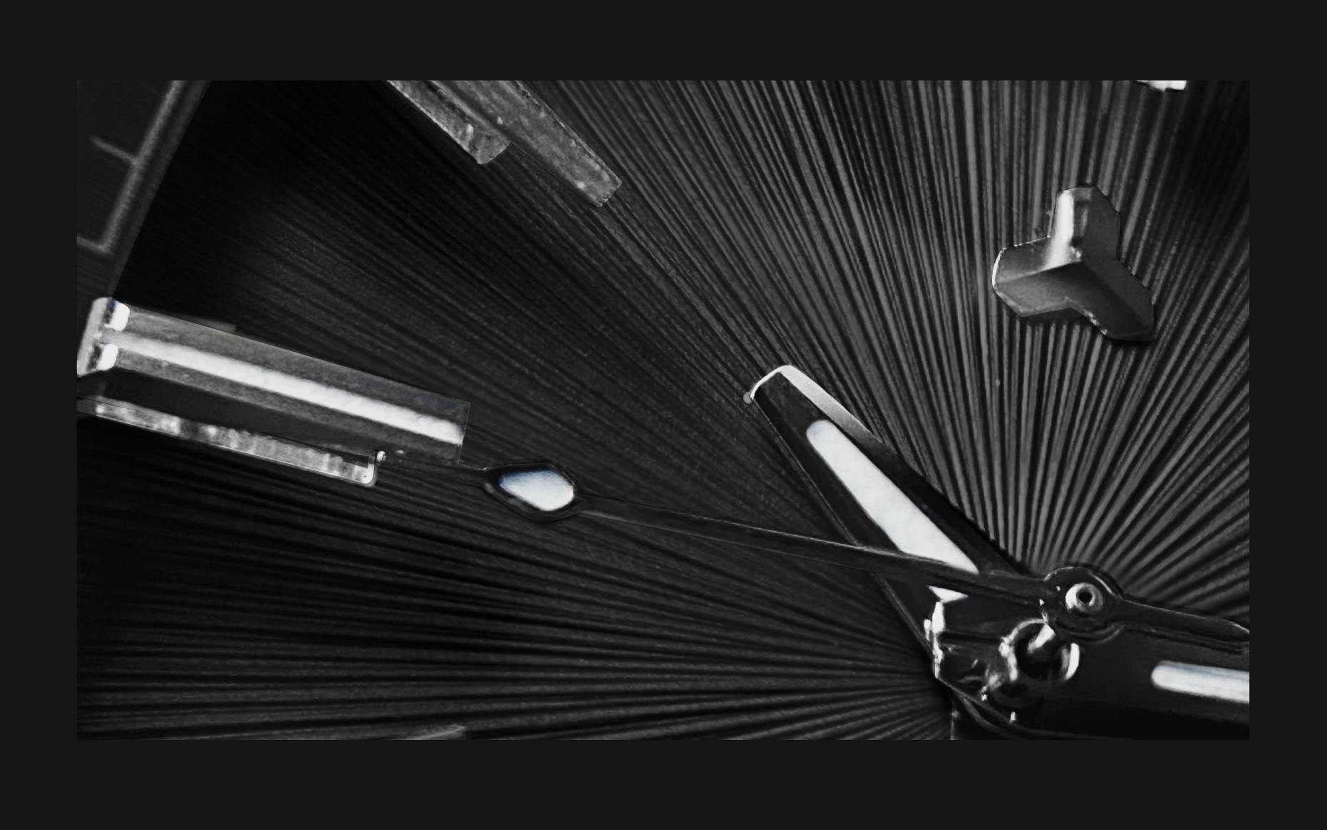 Flux Watch in Vintage black, macro shot focusing on the black dial and sharp silver hour markers