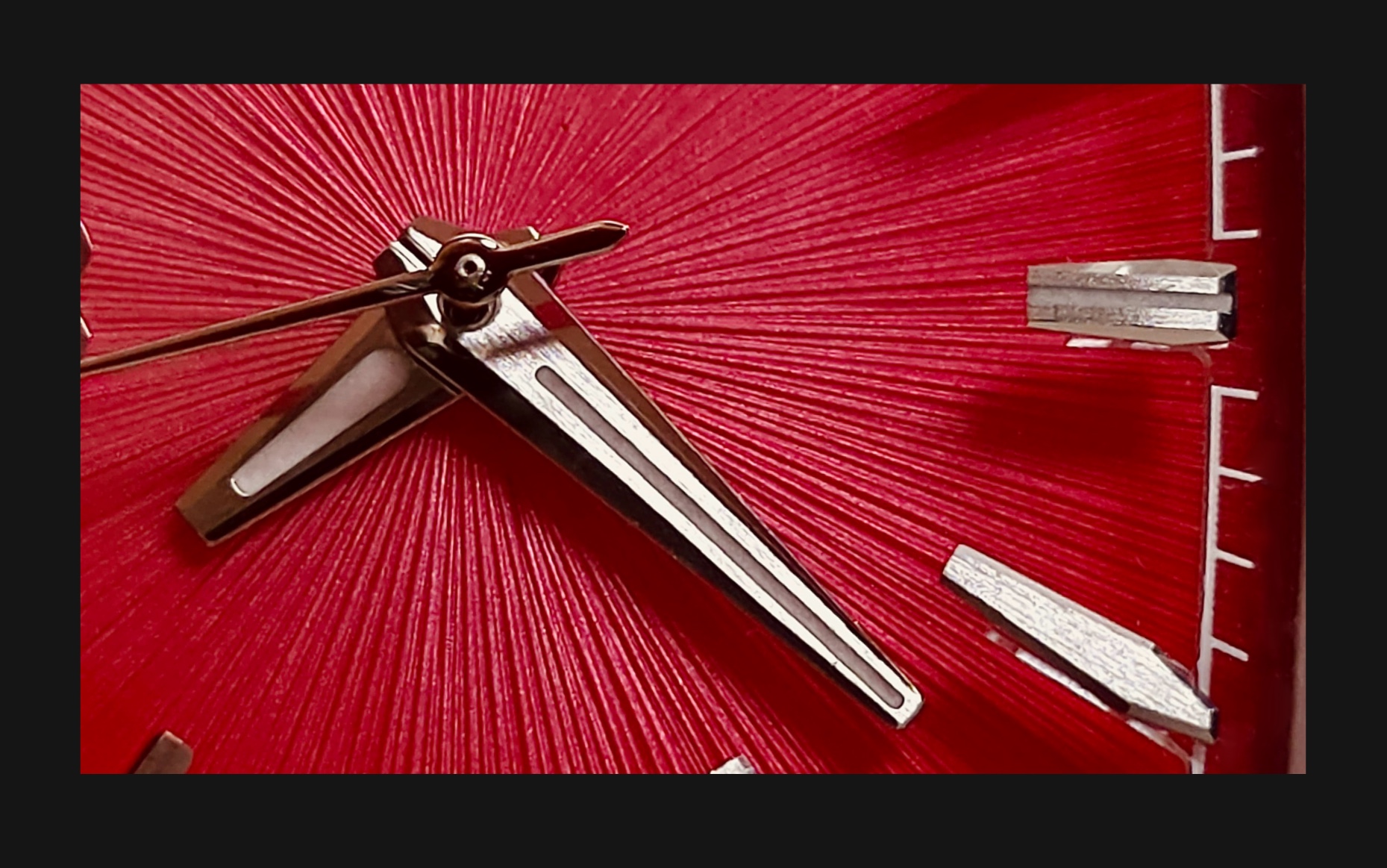 Flux Watch in adrenaline red, macro shot focusing on the red dial and sharp silver hour markers